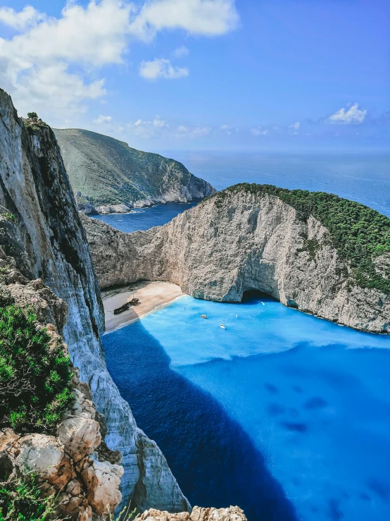 a large body of water next to a cliff, by Niko Henrichon, pexels contest winner, renaissance, alexandros pyromallis, square, today\'s featured photograph 4k, crystal clear blue water