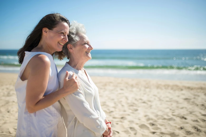 a woman standing next to an older woman on a beach, highly relaxed, profile image, trending photo, australian