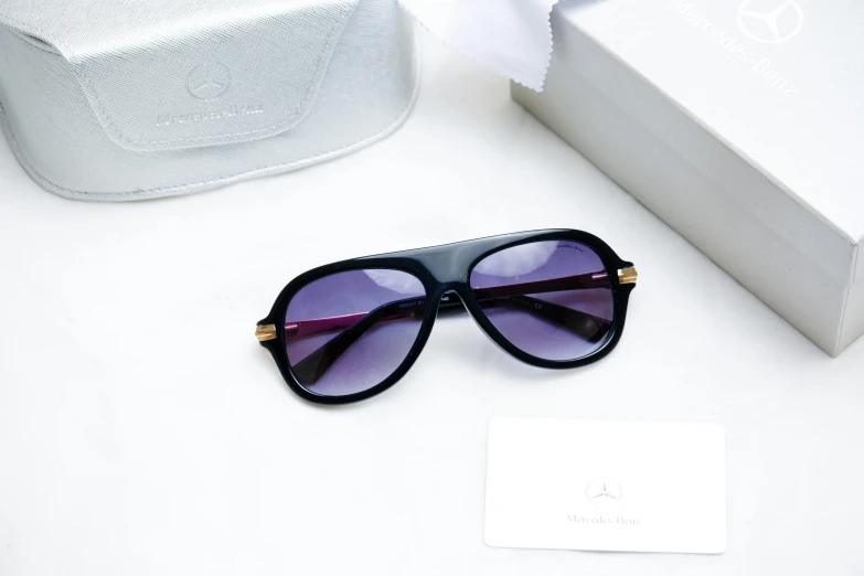 a pair of sunglasses sitting on top of a table, violet and black, luxury brand, marc, thumbnail