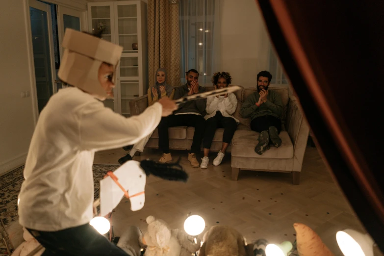 a group of people sitting around a living room, an album cover, pexels contest winner, puppet on a string, ( ( theatrical ) ), at the party, casting magic spell