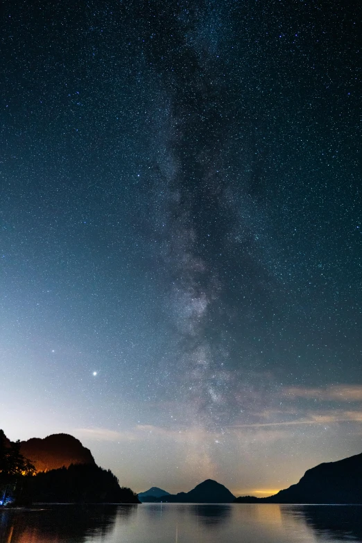 a boat sitting on top of a lake under a night sky, by Daniel Seghers, trending on unsplash, calanque, panorama view of the sky, the milk way up above, brown