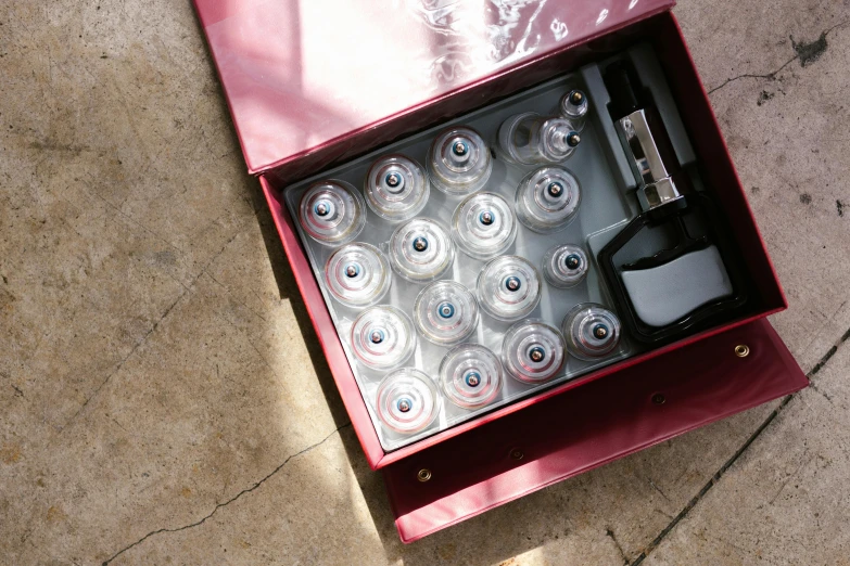 a box that has a bunch of bottles in it, an album cover, unsplash, nebulizer equipment, top view, ffffound, embedded in clear epoxy