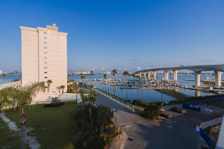 a view of a bridge over a body of water, full building, sun coast, city views, full room view