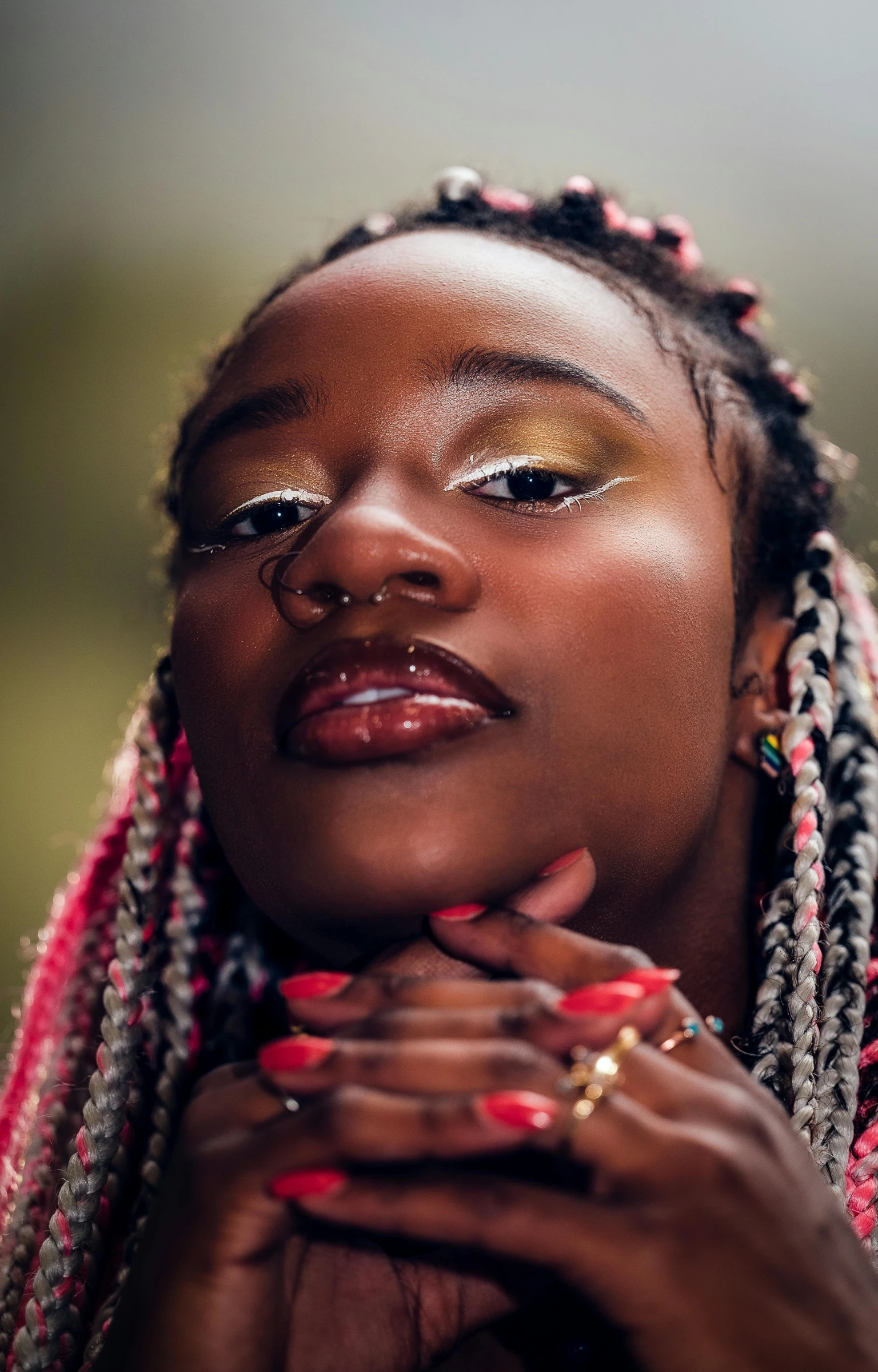 a woman with braids is posing for a picture, an album cover, inspired by Ras Akyem, trending on pexels, hand on her chin, shiny glossy skin, heavy gesture style closeup, richly colored