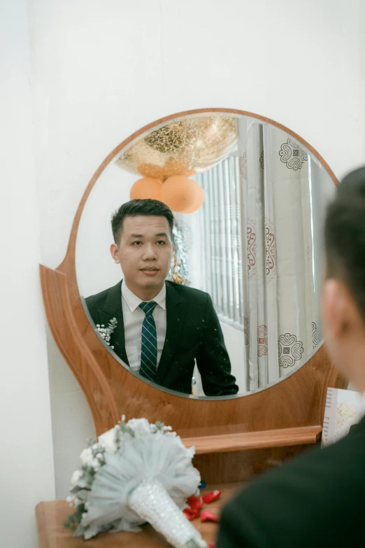 a man in a suit standing in front of a mirror, a picture, by Yosa Buson, pexels contest winner, dang my linh, oval face, wedding, around 1 9 years old