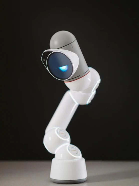 a robot that is sitting on top of a table, glowing mechanical eye camera, white, robotic left arm, detailed product shot