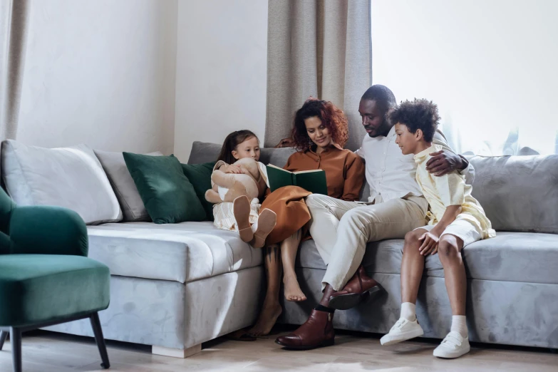 a group of people sitting on top of a couch, pexels contest winner, family, reading, te pae, profile image