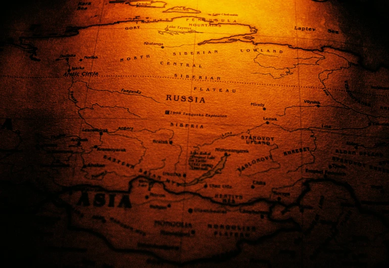 a close up of a map on a table, by Emma Andijewska, pexels contest winner, regionalism, ussr, dark warm light, mongol, thumbnail