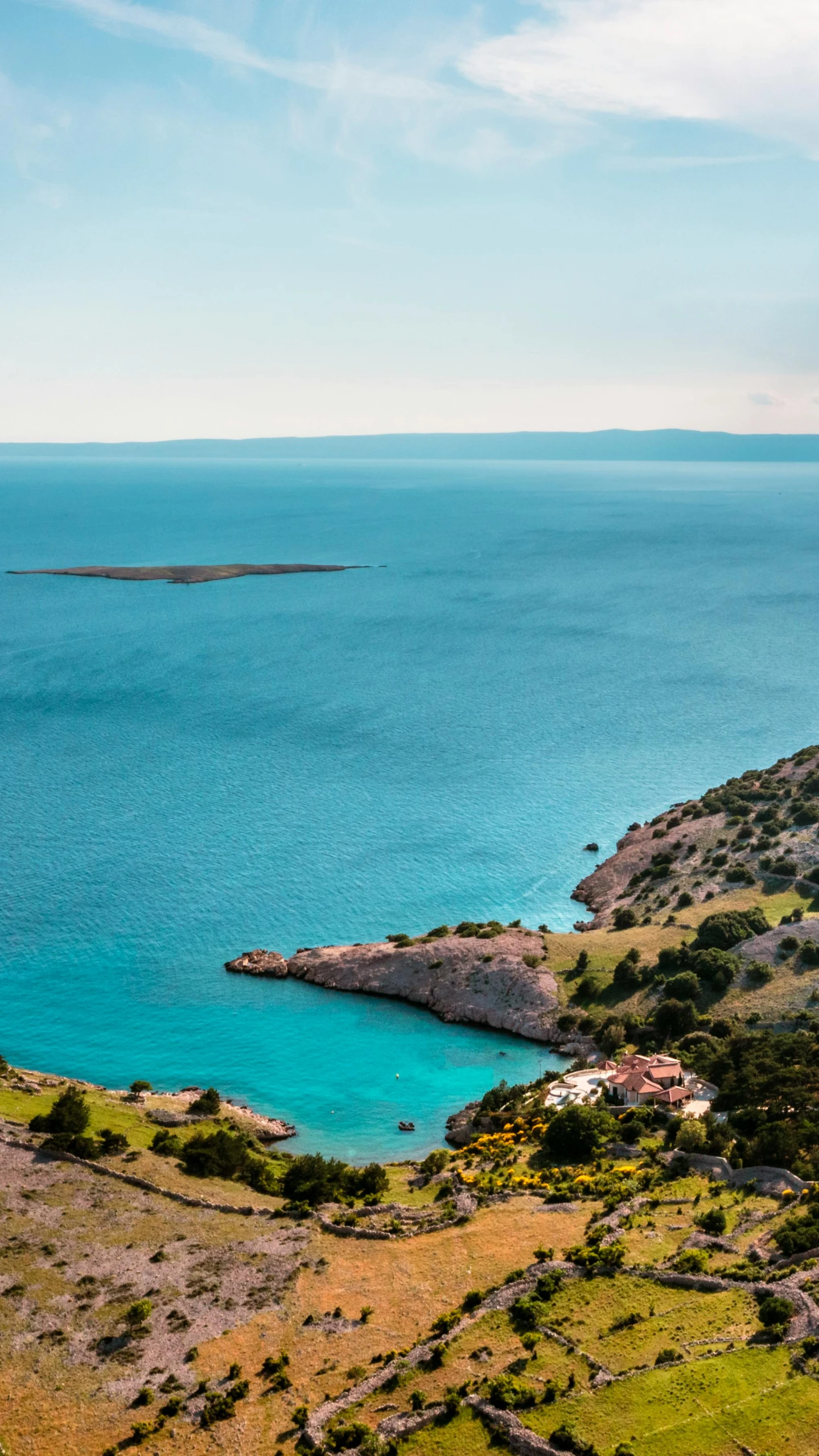 a large body of water next to a lush green hillside, pexels contest winner, les nabis, croatian coastline, red sea, slide show, greenish blue tones