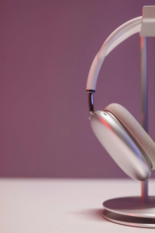 a pair of headphones sitting on top of a stand, iridescent titanium, rectangle, up-close, eye - level medium shot