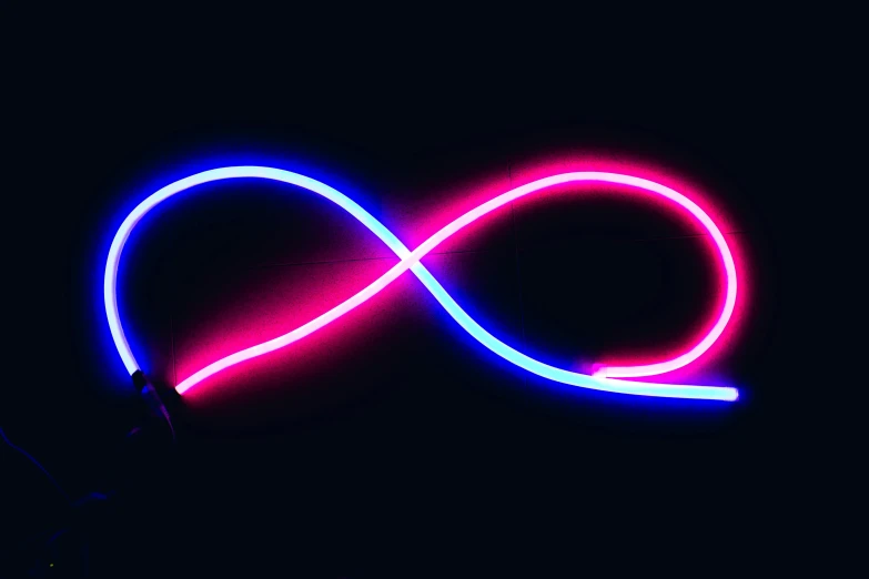 a person holding a neon light up in the dark, by Julian Allen, generative art, infinity symbol, blue and pink, thick looping wires, blue and red two - tone