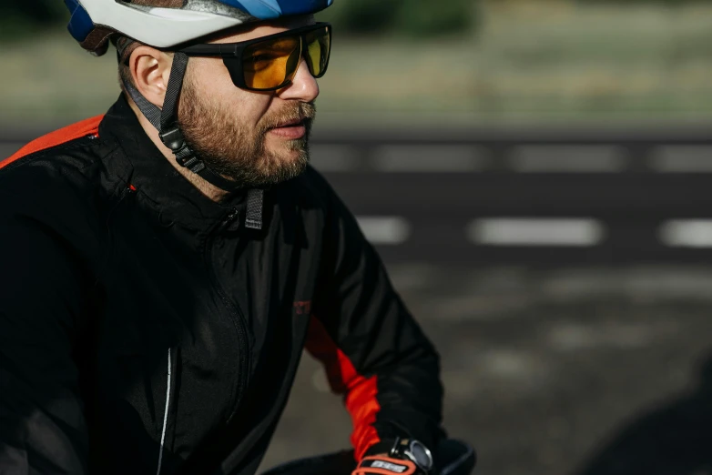 a man on a bike wearing a helmet and goggles, profile image, polarized sports sunglasses, shot on sony a 7, black