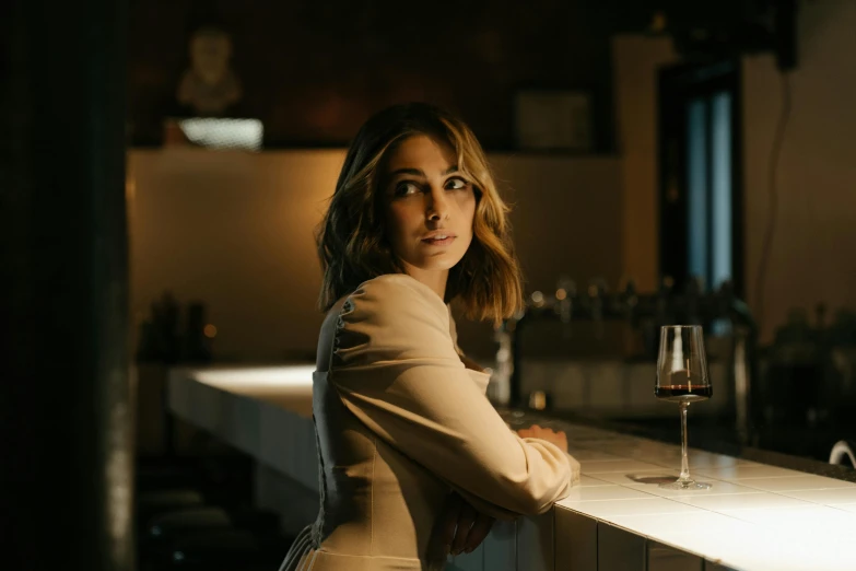 a woman sitting at a bar with a glass of wine, a portrait, by Lee Loughridge, pexels contest winner, olivia culpo, imogen poots, ::