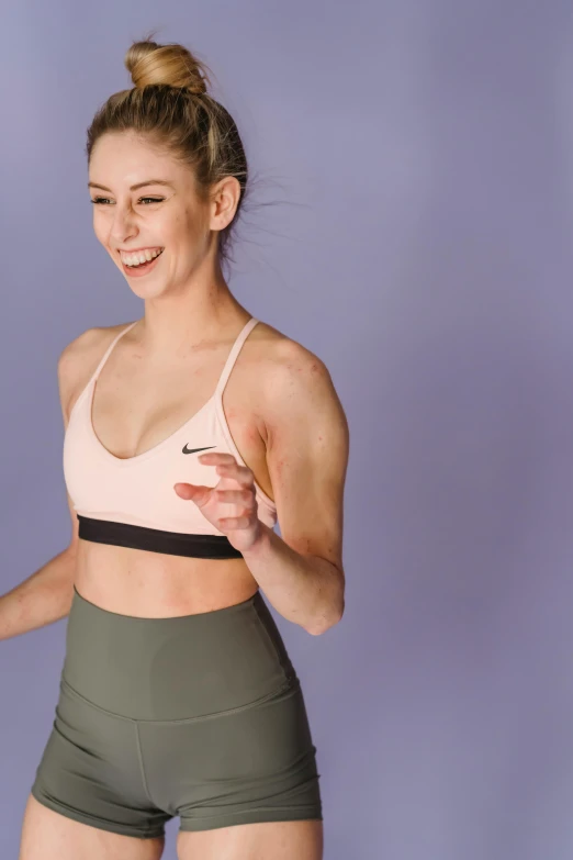 a woman in a sports bra top holding a tennis racquet, trending on pexels, figuration libre, smiling and dancing, lilac, half body cropping, on simple background