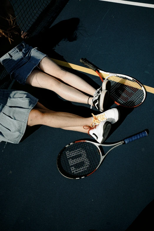 a woman standing on top of a tennis court holding a racquet, by Carey Morris, unsplash, photorealism, jean and multicolor shoes, a high angle shot, wenjun lin, 2000s photo