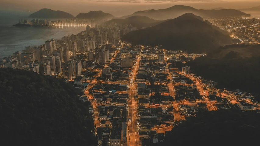 a view of a city from the top of a mountain, by Daniel Lieske, pexels contest winner, brazilian, warm summer nights, thumbnail, brown