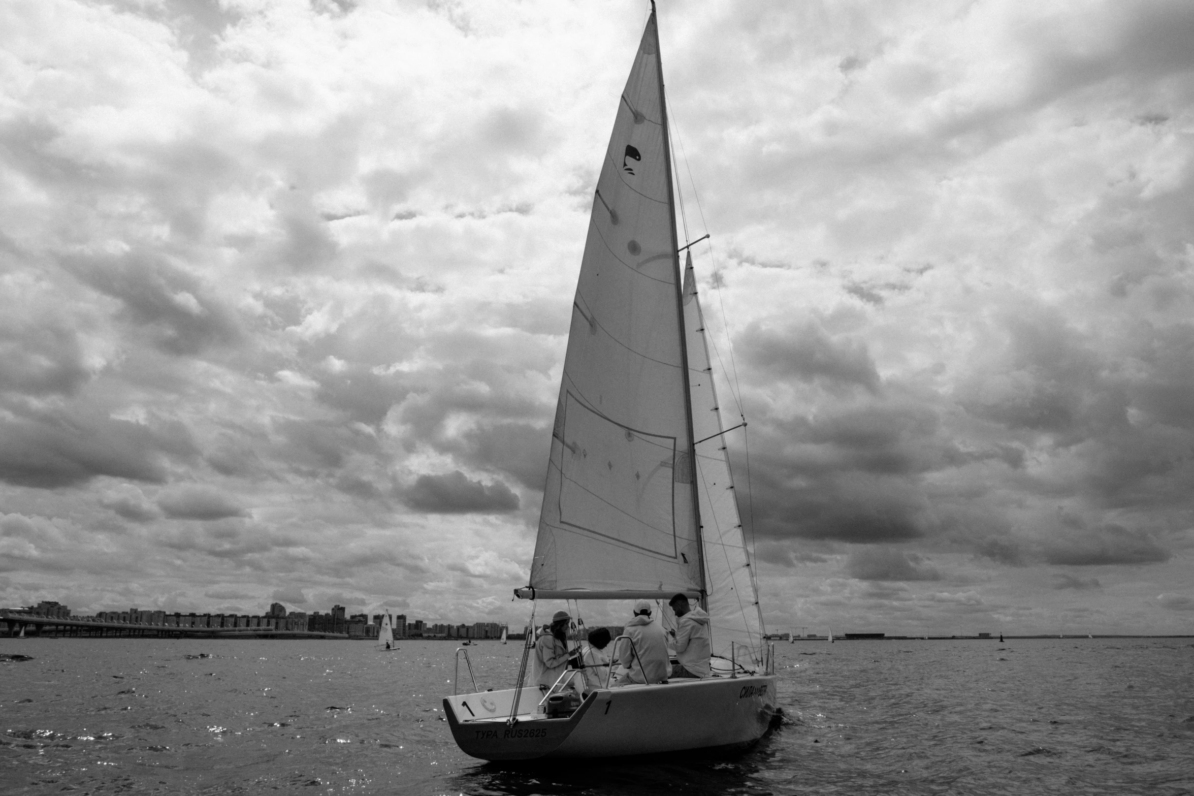 a black and white photo of a sailboat in the water, camaraderie, boston, 1 female, conor walton