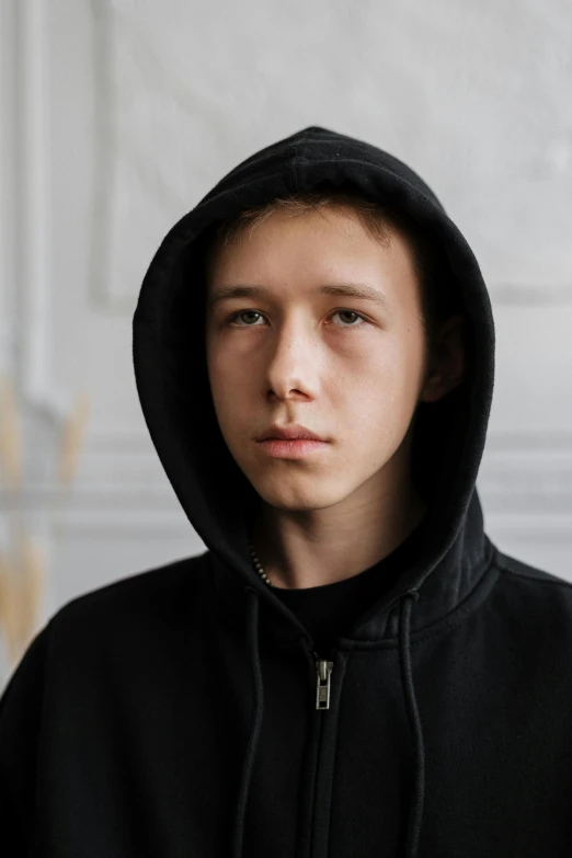 a close up of a person wearing a hoodie, a character portrait, shutterstock, antipodeans, he looks like tye sheridan, casual black clothing, oleg korolev, smol