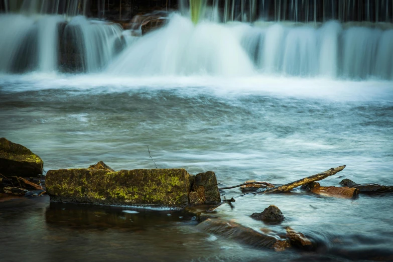 a small waterfall in the middle of a forest, by Jesper Knudsen, pexels contest winner, hurufiyya, old lumber mill remains, medium format. soft light, water ripples, album