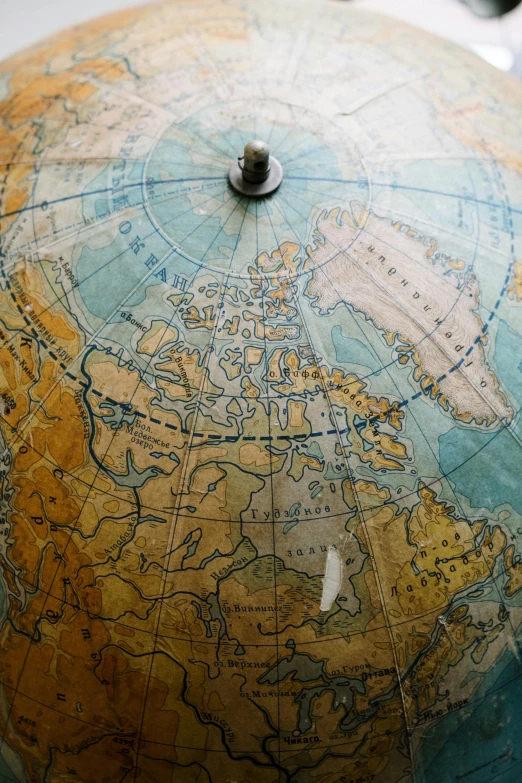 a close up of a globe on a table, inuit heritage, mapbox, top down shot, the age of discovery