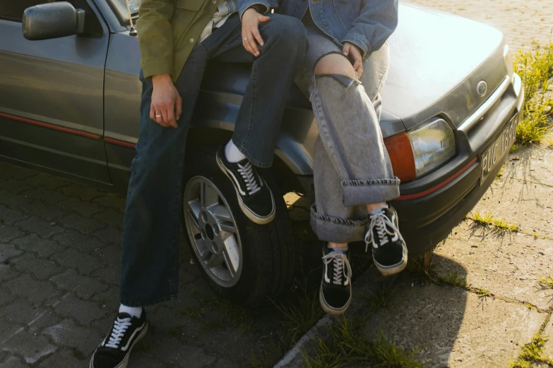 a man and a woman sitting on top of a car, trending on pexels, photorealism, blue jeans and grey sneakers, retro aesthetic, creepers, van