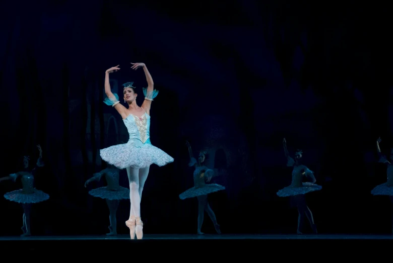 a woman in a white dress standing on a stage, pexels contest winner, arabesque, wearing a tutu, blue, production photo, “diamonds