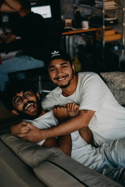 a couple of men sitting on top of a couch, pexels contest winner, hurufiyya, insane smile, jayison devadas, hugging each other, round teeth and goofy face