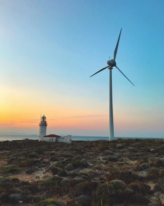 a couple of windmills sitting on top of a hill, a picture, pexels contest winner, a photo of the ocean, 🚿🗝📝, last light, green energy