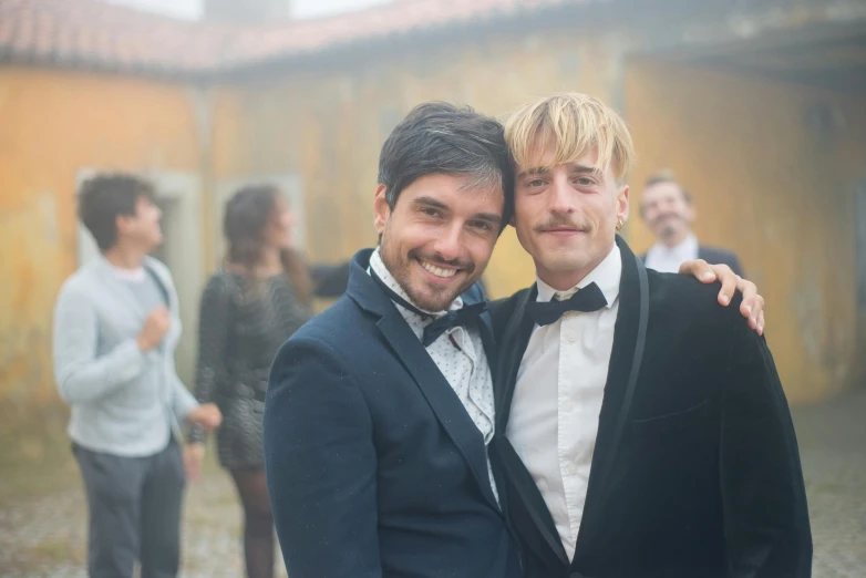 a couple of men standing next to each other, pexels contest winner, renaissance, at the party, wearing tuxedo, riccardo scamarcio, hazy