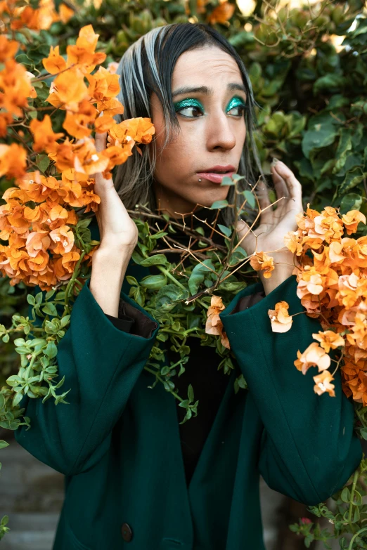 a woman holding a bunch of flowers in front of her face, an album cover, inspired by Elsa Bleda, trending on pexels, woman made of plants, teal orange color palette 8k, cinematic outfit photo, deep green eyes