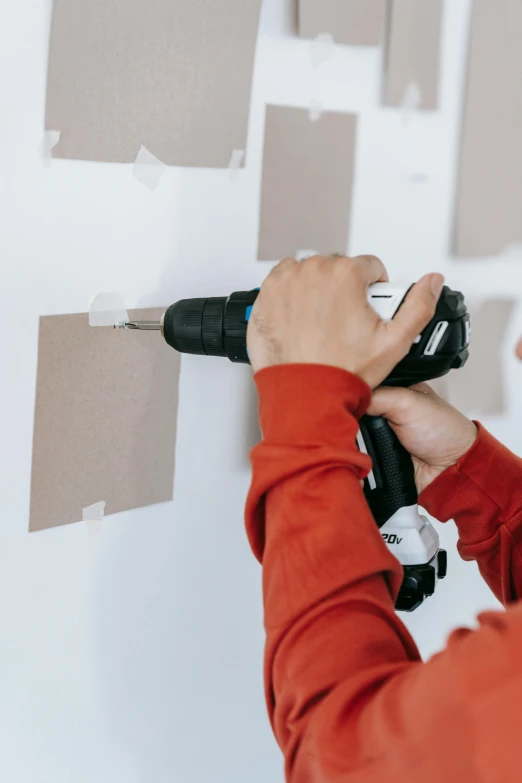 a person using a drill to paint a wall, pexels contest winner, arbeitsrat für kunst, paper cut out, electrical signals, inspect in inventory image, diecut