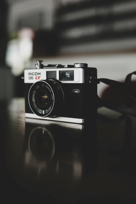 a camera sitting on top of a wooden table, a picture, unsplash contest winner, photorealism, yashica t 4, icon, short dof, shot on nicon camera