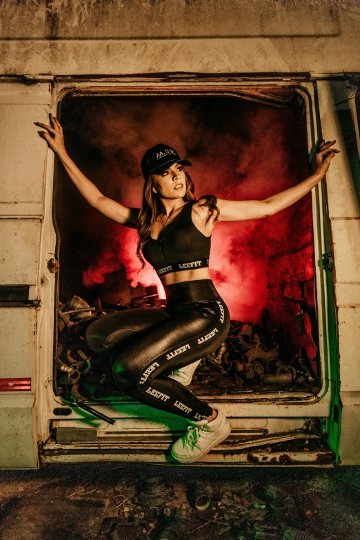 a woman sitting on top of a green scooter, an album cover, by Julia Pishtar, graffiti, jet black leggins, fire lit, model is wearing techtical vest, trucks