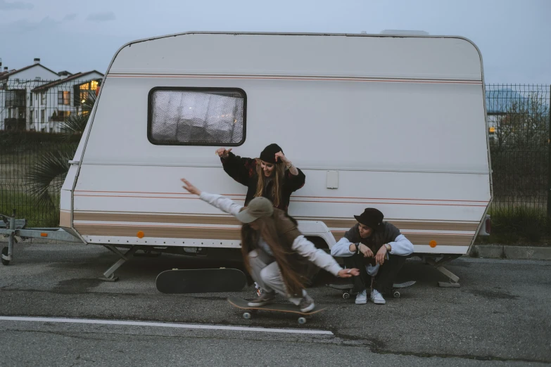 a man riding a skateboard next to a woman on a skateboard, by Attila Meszlenyi, pexels contest winner, realism, next to an rv, people panicking, caravan, 15081959 21121991 01012000 4k