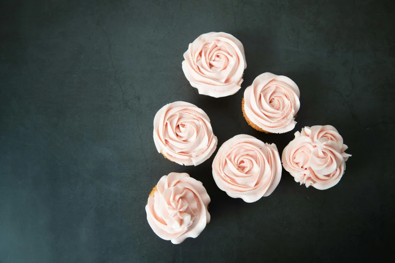 a bunch of cupcakes sitting on top of a table, trending on pexels, arabesque, natural point rose', on a gray background, flowing salmon-colored silk, smooth edges