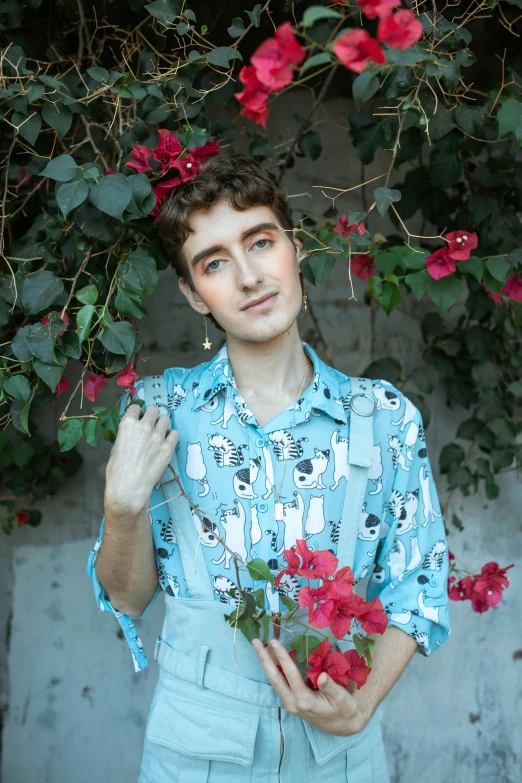 a man holding a bouquet of flowers in front of a wall, an album cover, by Julia Pishtar, trending on pexels, attractive androgynous humanoid, with hawaiian shirt, he is about 20 years old | short, porches