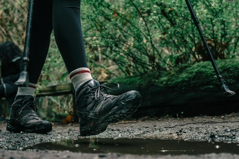 a person walking across a puddle of water, trekking in a forest, profile image, sneaker photo, wearing adventure gear