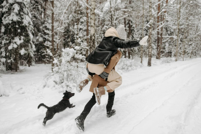 a woman is playing with her dog in the snow, pexels contest winner, jumping for joy, tiny cat riding a labrador, 🦩🪐🐞👩🏻🦳, cottagecore