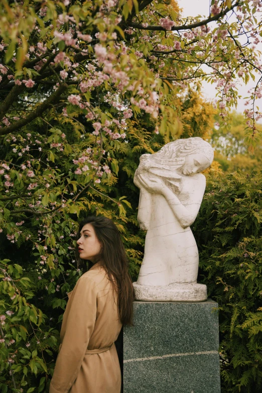 a woman standing next to a statue in a park, inspired by Elsa Bleda, unsplash, art nouveau, blossoming, thoughtful ), made of marble, still from a music video