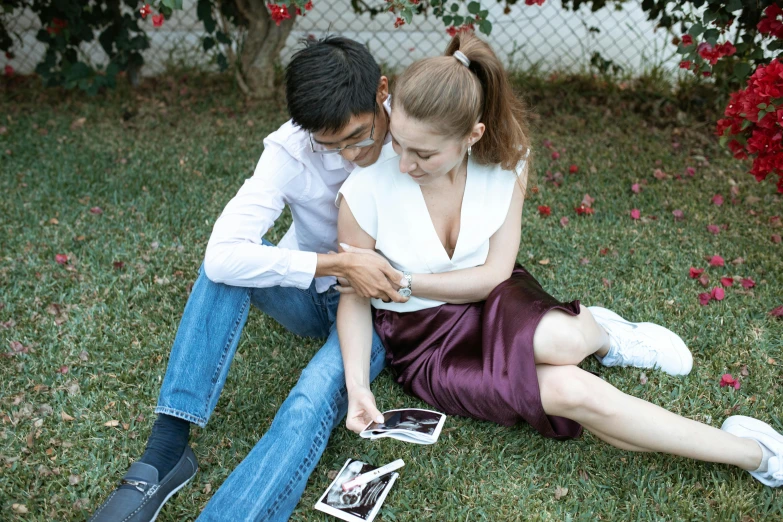 a man and a woman sitting on the ground next to each other, a polaroid photo, by Julia Pishtar, renaissance, realistic footage, 15081959 21121991 01012000 4k, in garden, cinematic outfit photo