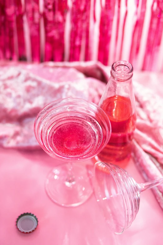 a couple of wine glasses sitting on top of a table, pink vibe, jelly - like texture, pink clothes, drinking cough syrup