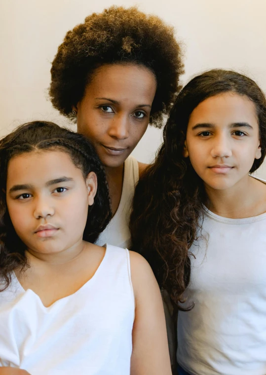 a group of young girls sitting next to each other, by Ruth Abrahams, antipodeans, mixed race woman, 3 5 year brazilian mother, profile image, looking serious