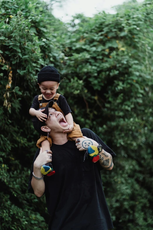 a man holding a small child in his arms, inspired by The Family Circus, pexels contest winner, pete davidson, mickey mouse, on trees, cutecore clowncore