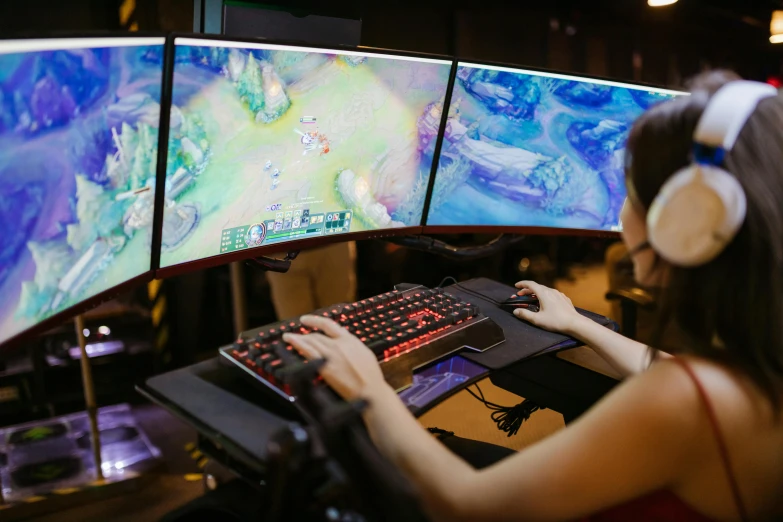 a woman wearing headphones playing a video game, stacked computer screens, from league of legends, a high angle shot, no - text no - logo