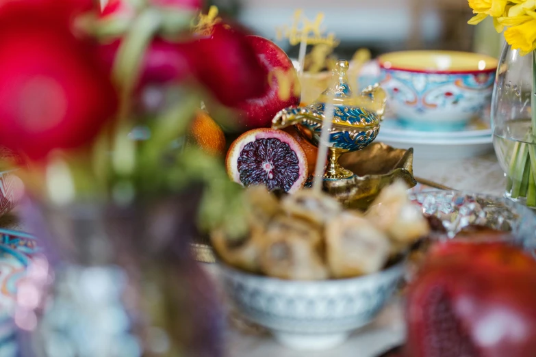 a close up of a plate of food on a table, a still life, inspired by Riad Beyrouti, unsplash, rococo, dragon fruits, “ golden cup, prussian blue and venetian red, background image