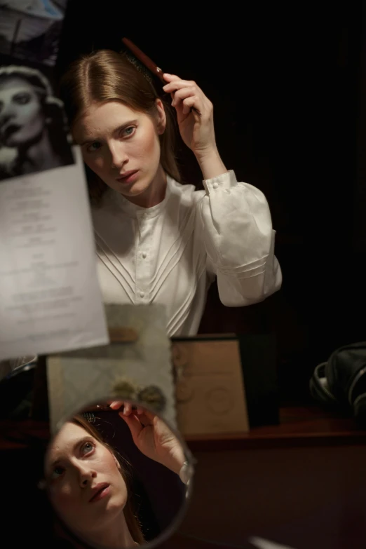 a woman brushing her hair in front of a mirror, a portrait, inspired by Anna Füssli, unsplash, renaissance, victorian vampire, wearing lab coat and a blouse, anna kendrick, ignant