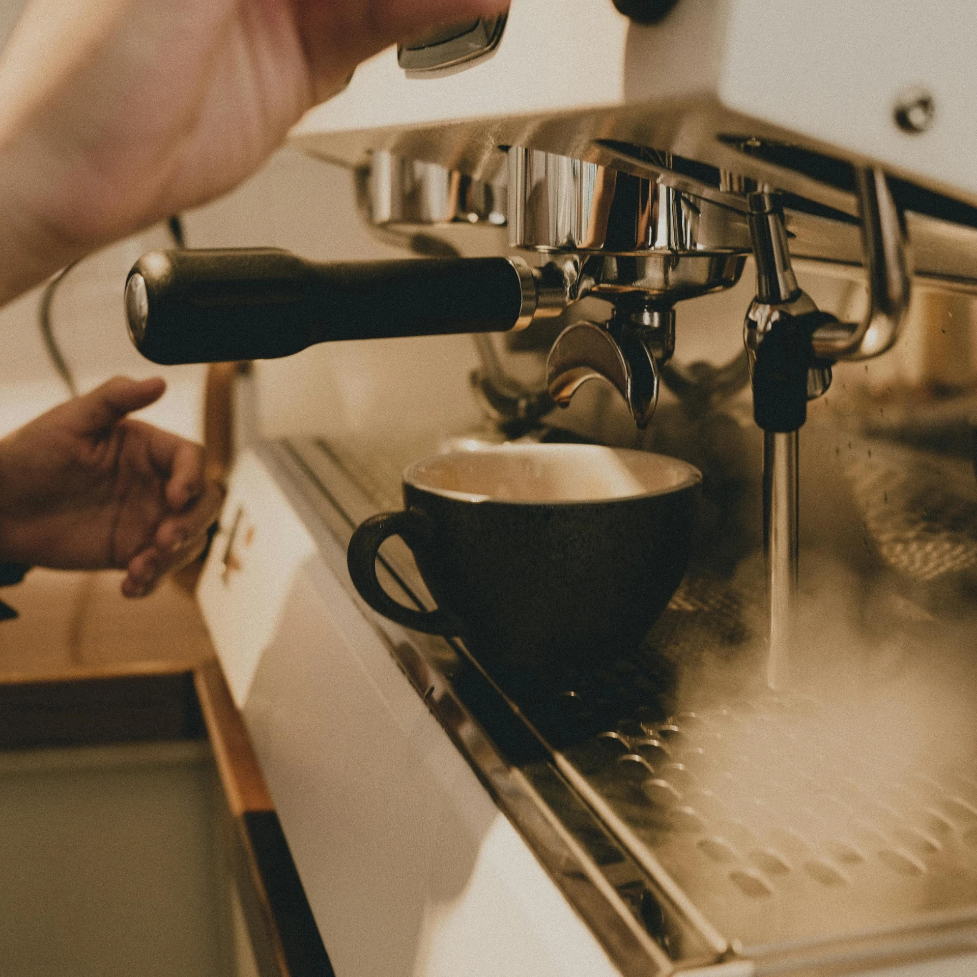 a person using a coffee machine in a kitchen, inspired by Elsa Bleda, pexels contest winner, huge cup of coffee, creamy, thumbnail, vibration