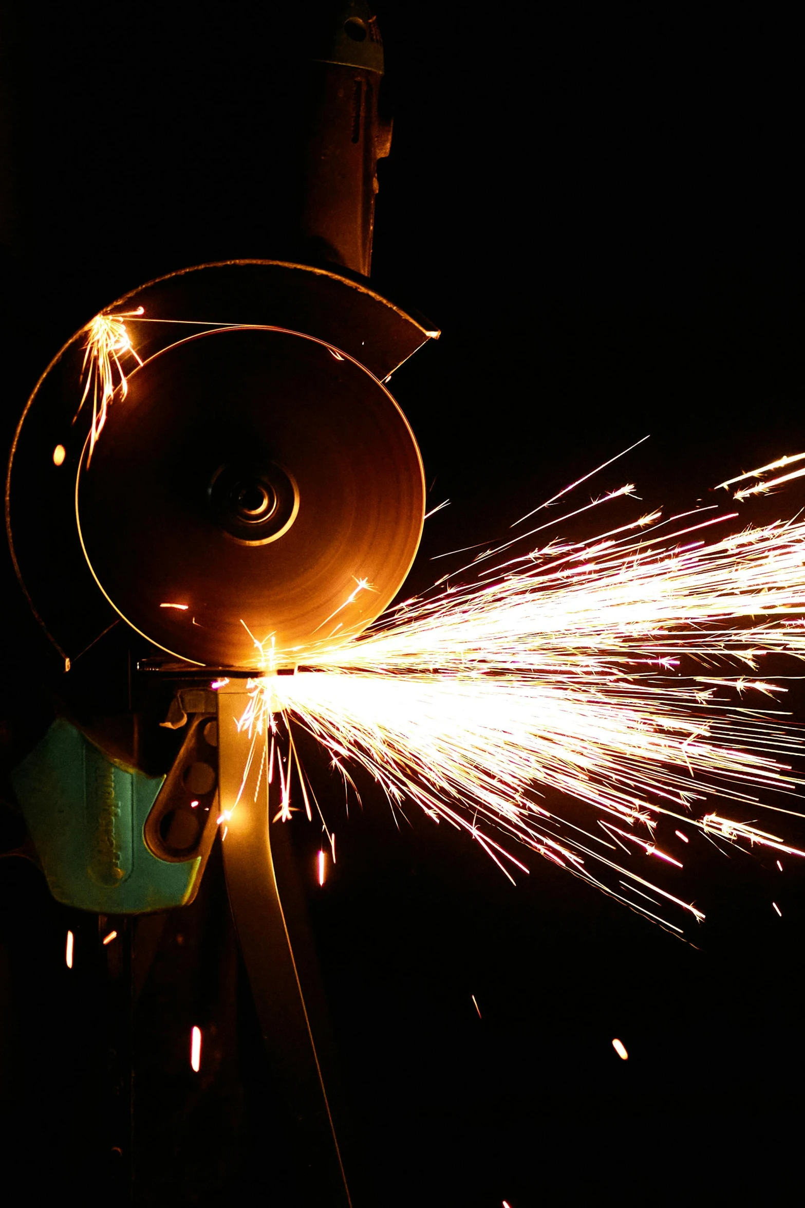 a person using a grinder on a piece of metal, by Everett Warner, pexels contest winner, nighttime, slide show, 2 0 1 0 photo, panel