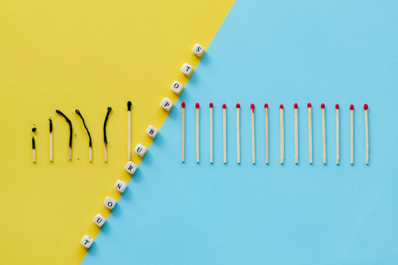 a row of matchsticks next to a row of matches, by Julia Pishtar, trending on pexels, process art, on a yellow canva, colorful medical equipment, model photograph, interrupting the big game