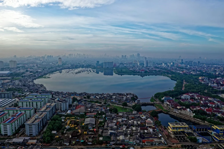 a large body of water surrounded by lots of buildings, by Basuki Abdullah, pexels contest winner, hurufiyya, wide river and lake, south jakarta, slide show, background image